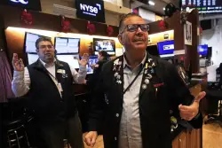 US stocks power within 3% of their record as Wall Street closes out a winning week